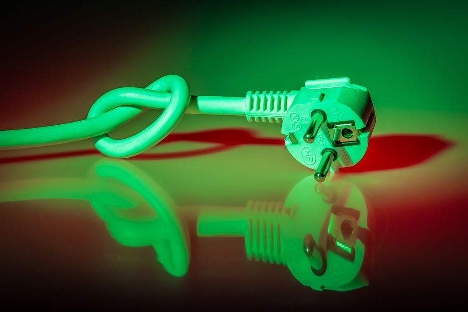 Close-up of two hands carefully working to untangle a complex knot in a rope against a bright, clean background, symbolizi...